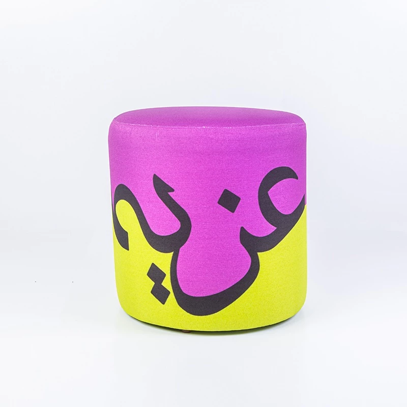 Ottoman Modern Chair featuring the word "Azima" in Arabic calligraphy – vibrant colors (purple and phosphorescent green) and an inspiring artistic design - King Hussein Cancer Foundation