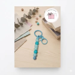 A keychain decorated with beads and a delicate in an elegant design