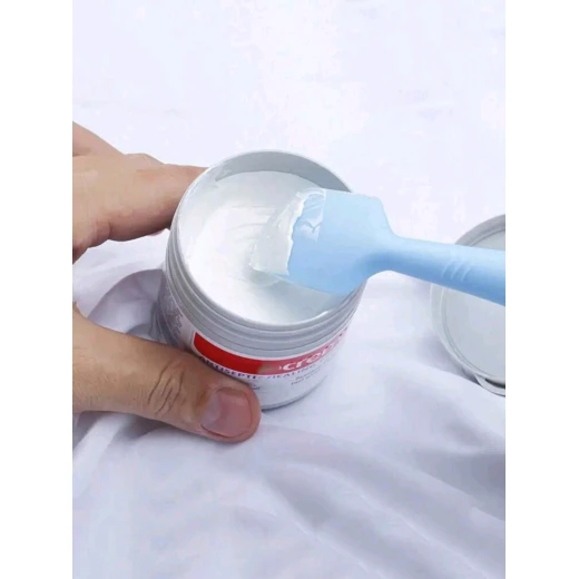 Small blue silicone spatula for applying baby ointments and diaper rash cream, with a suction cup for convenient, hygienic storage - Image 2